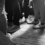 Legs of students at a social event (none facing eachother