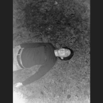student laying down in the grass